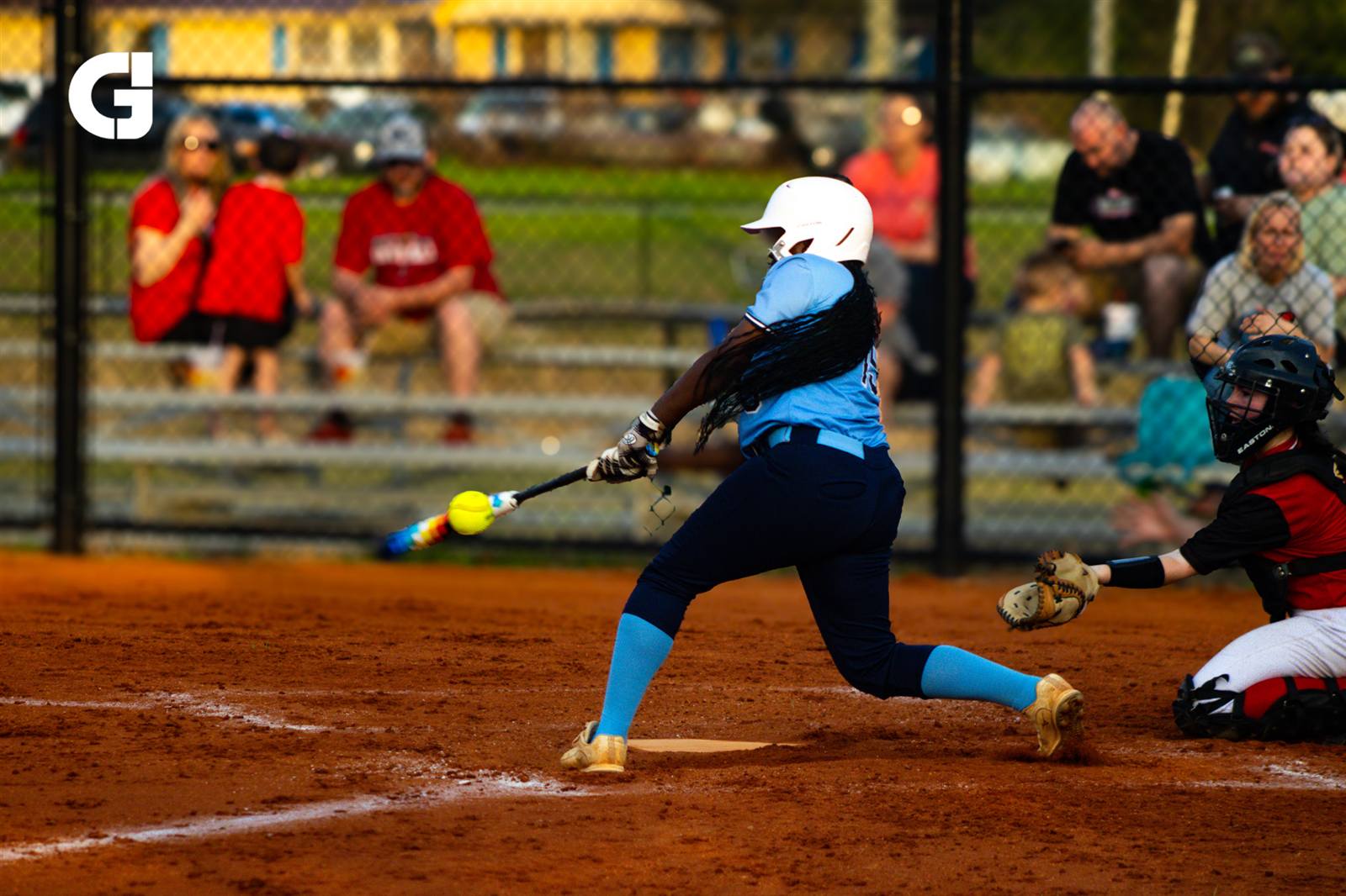 Softball player swinging the bat