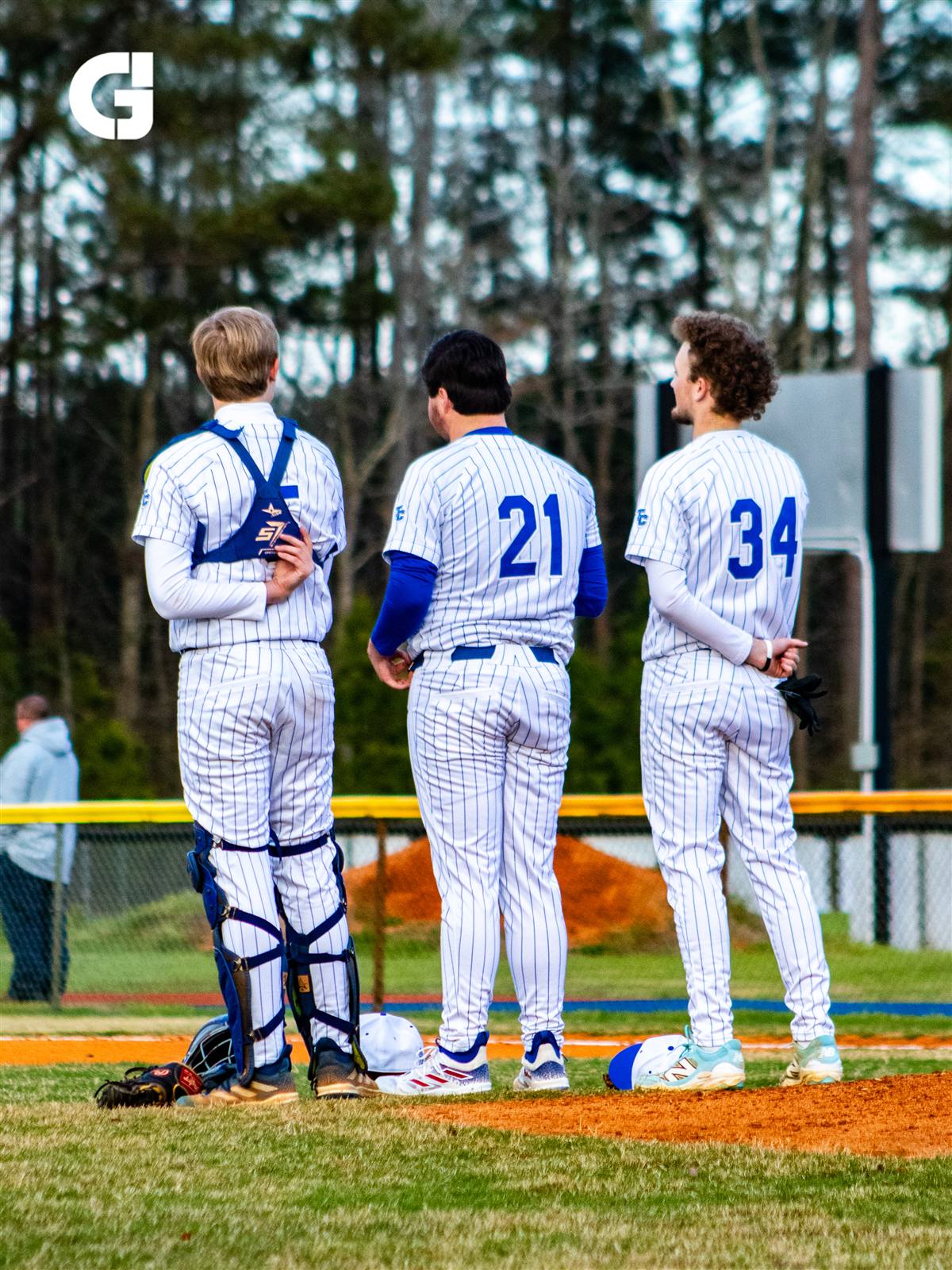 Baseball players standing together on the field