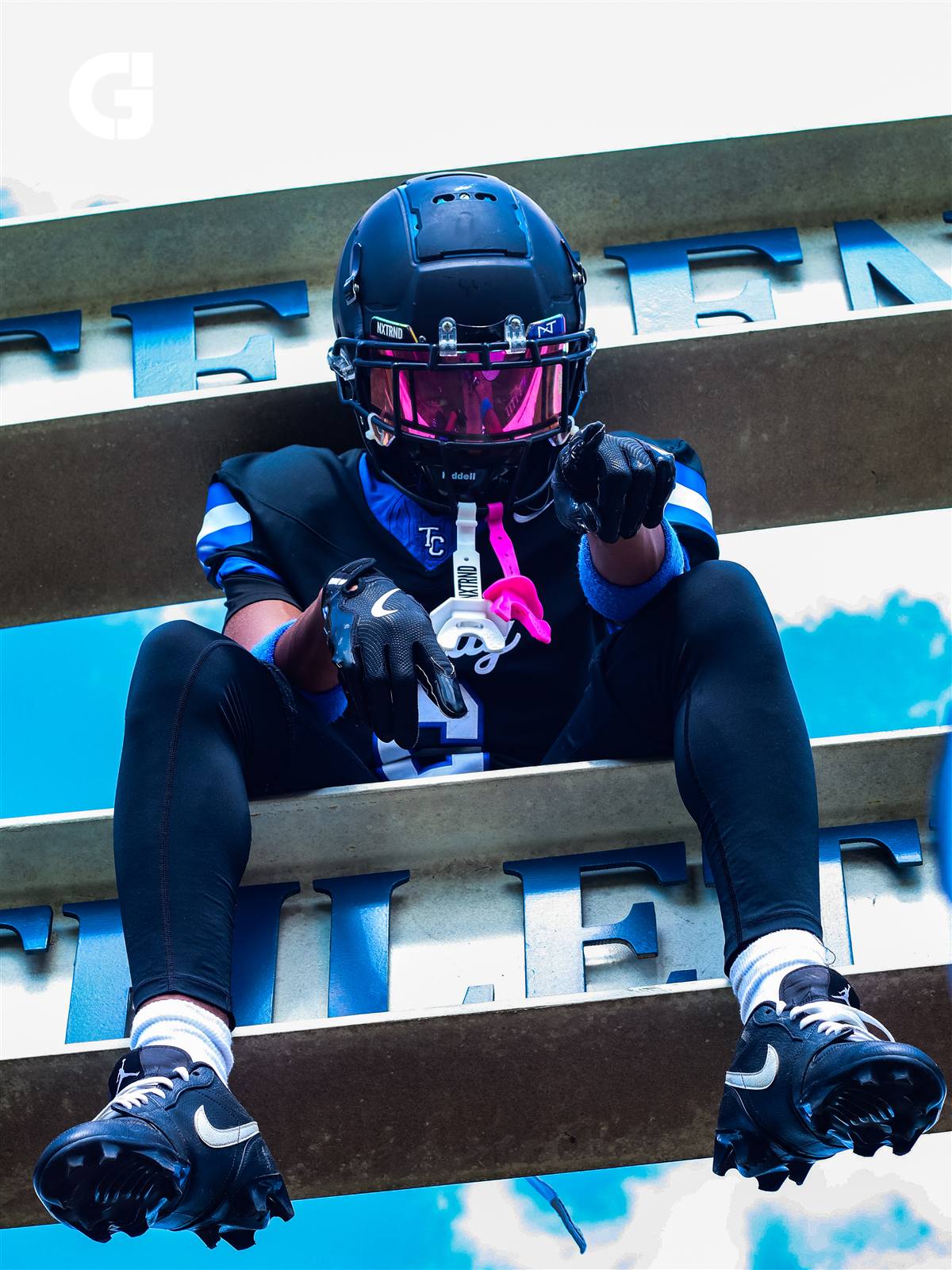 Football player seated in stadium